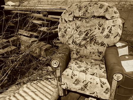 old broken armchair at the dump with boardsの写真素材