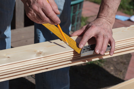 Builder measures the dimensions and draw a line cutの写真素材