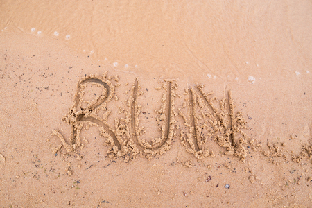 Inscriptions on the sand: runの写真素材