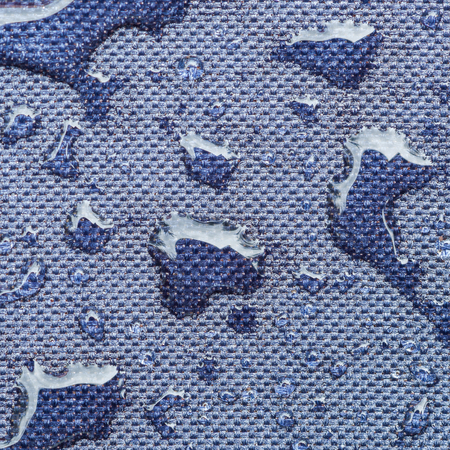 Macro water-repellent surface fabric travel accessories with water drops.の写真素材