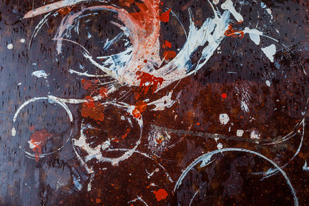 Abstract multi-colored stains on the brown surface