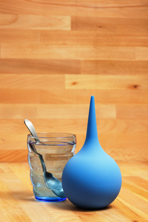 A glass of water and enema for the clean-out of stomach and treatment of constipationの写真素材