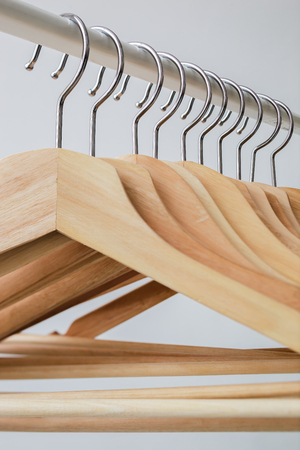 Wooden bright  hangers for coat and dress on the rackの写真素材