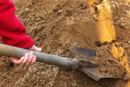 onstruction shovel stuck in the sand. break during work