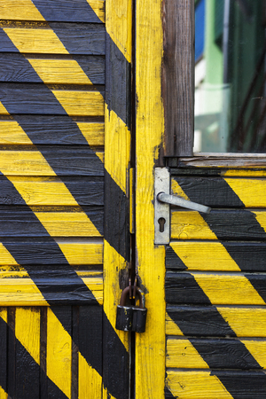 Wooden building painted in black and yellow strip