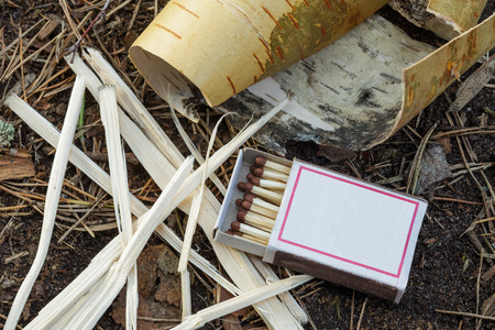 Matches in a box, and bark torch to ignite fireの写真素材