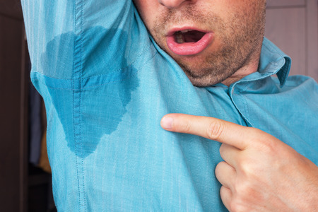 Sweaty armpit and a wet spot on his shirt because of the heat
