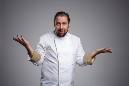 Cook throws up his hands in bewilderment. の写真素材