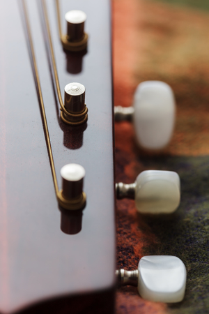 Guitar neck with stretched strings. close-up view
