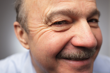 old man with a mustache looks curiouslyの写真素材