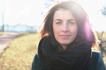 Portrait of a red-haired girl on the street. She looks forward and looks confidentlyの写真素材