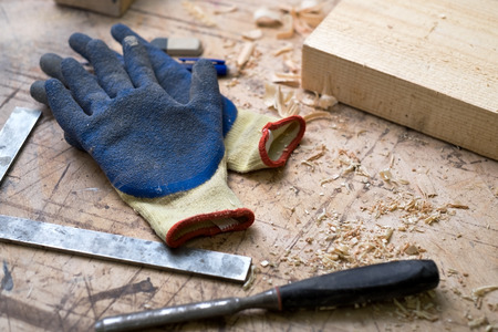 Protective gloves and carpentry on a desktop.の写真素材