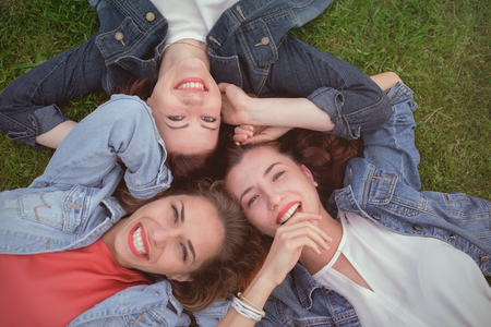 Happy friends in the park on a sunny day.の写真素材