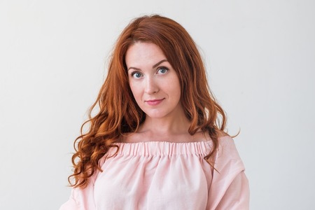 Caucasian woman model with ginger hair posing indoors