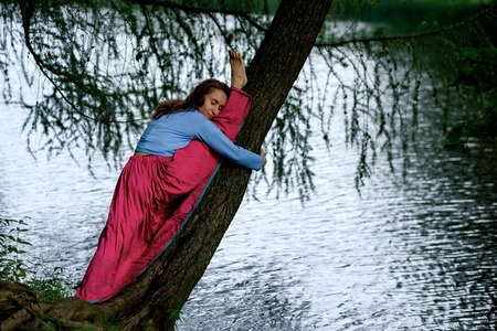 Slim sporty girl on white background sitting in splits, Monkey yoga pose, asana Hanumanasana, stretching practiceの写真素材