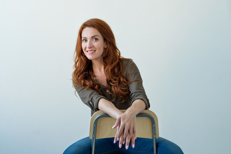 Caucasian woman model with ginger hair posing indoorsの写真素材