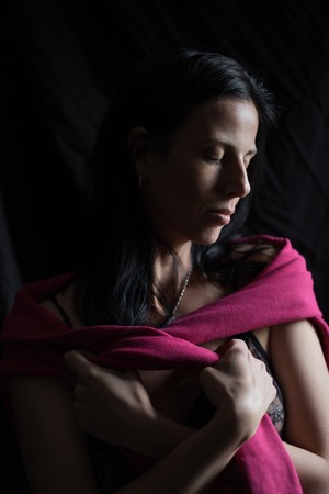 Studio portrait of caucasian woman with black long hair.の写真素材