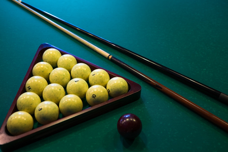 Russian billiards white balls, cue ball, wooden cue on a large table with green clothの写真素材