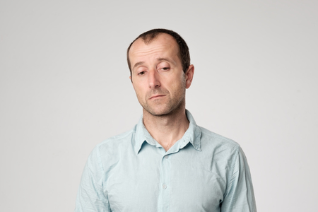Portrait of a mature sad man. He is dissapointed with news. Lost job