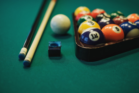 Playing billiard. Billiards balls and cue on green billiards table. Billiard sport concept. Pool billiard game.の写真素材