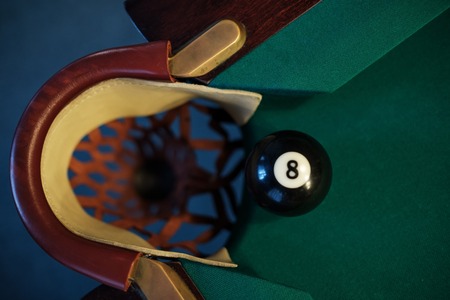 Billiard ball in a pool table near pocket. focus on the eight ball