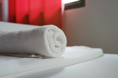 White towel in the hotel room. A cozy and simple room.の写真素材