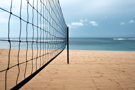 Volleyball net on the sand beach on tropical island. Sport during vacationの写真素材