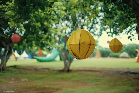 Decor of forest for vintage party. Hanging lanterns on trees. Fairytale retro forest.の写真素材