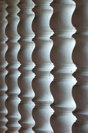 Several white curved columns in one row. Architectural detail of the interiorの写真素材