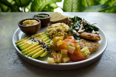 Vegan tofu with avocado, bread, vegetables and source close-up on a plate. Concept of eco healthy dietの写真素材