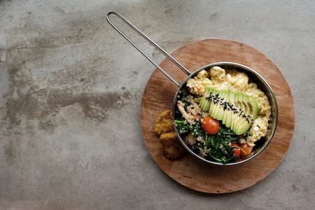 Vegan tofu with avocado, bread, vegetables and source close-up on a plate. Concept of eco healthy dietの写真素材