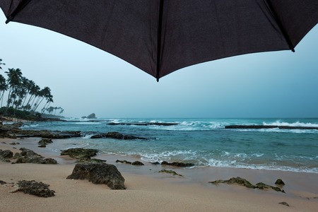 view on ocean during rain in sri lanka. Umbrella part on topの写真素材