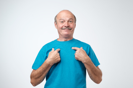 You talking to me. Caucasian mature man pointing to himself with question if he did something wrong.の写真素材