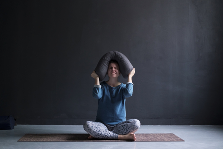 Girl cannot concentrate, feeling annoyed from noise. Displeased mature european woman on yoga class, frowning and sulkingの写真素材
