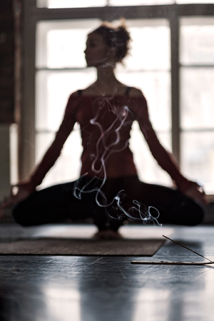 Blurred woman practicing yoga in Toe Balanceの写真素材
