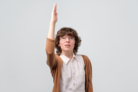 curly woman in glasses ready to answer on questionの写真素材