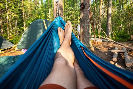 Man resting in a hammock on a summer day during vacation.の写真素材