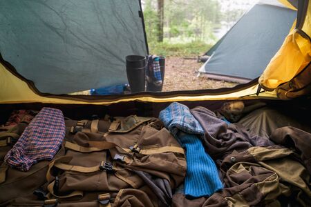 Inside a tracking tent for tourism. Clothes blanket and other staff inside opened tent