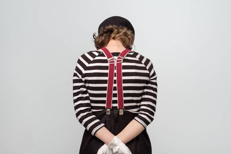 Sad young mime woman turning back being offended.の写真素材
