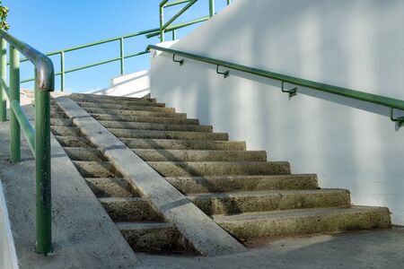 ramp for the wheelchair and stairs in an urban environment