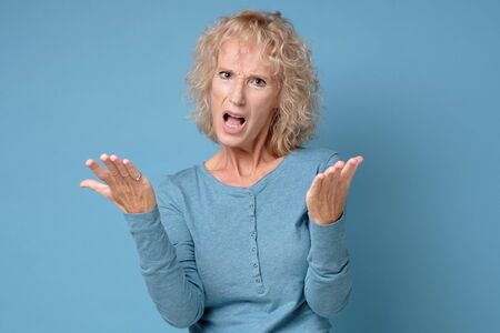 Angry woman unhappy, annoyed by something. Negaative facial human emotion.の写真素材