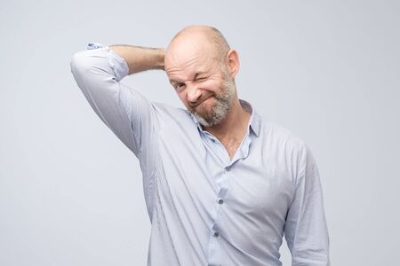 Close up portrait of a casual mature pensive businessman. Studio shotの写真素材