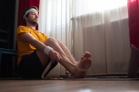 Young man sitting in paschimottanasana or Intense Dorsal Stretch poseの写真素材
