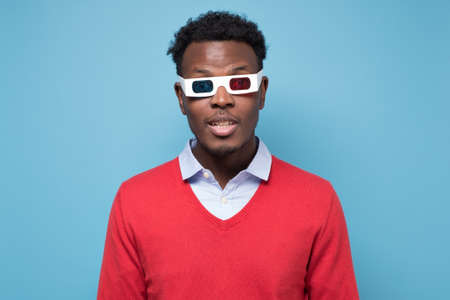 African american man in 3D glasses watching interesting movie on screen.の写真素材