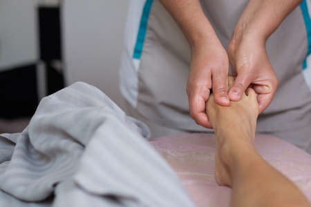 Foot massage in the spa salon at spa salonの写真素材
