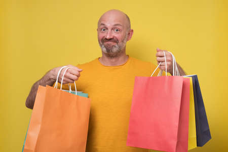 man with packing bags over his shoulder