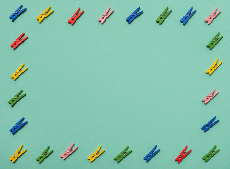 Small wooden clothes pins on colored backgroundの写真素材