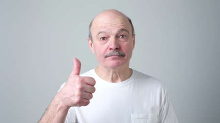 Happy senior spanish man showing thumbs up