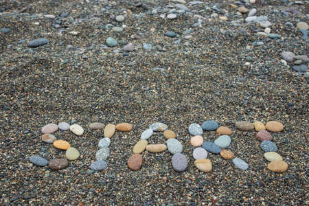 Start made from stones on sandy beachの写真素材