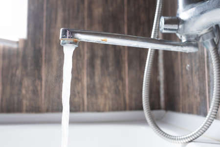 faucet with flowing water in wash sink. Somebody forgets to turn off water.の写真素材